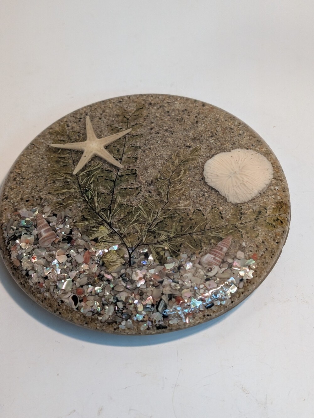 Lucite resin trivet featuring embedded beach sand, abalone shells, and starfish.